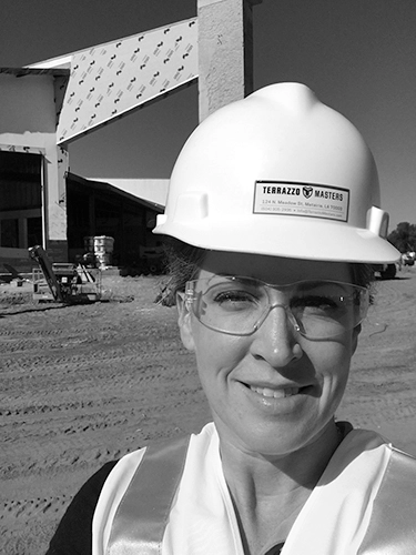 Adrienne with white hard hat on a construction site for market research